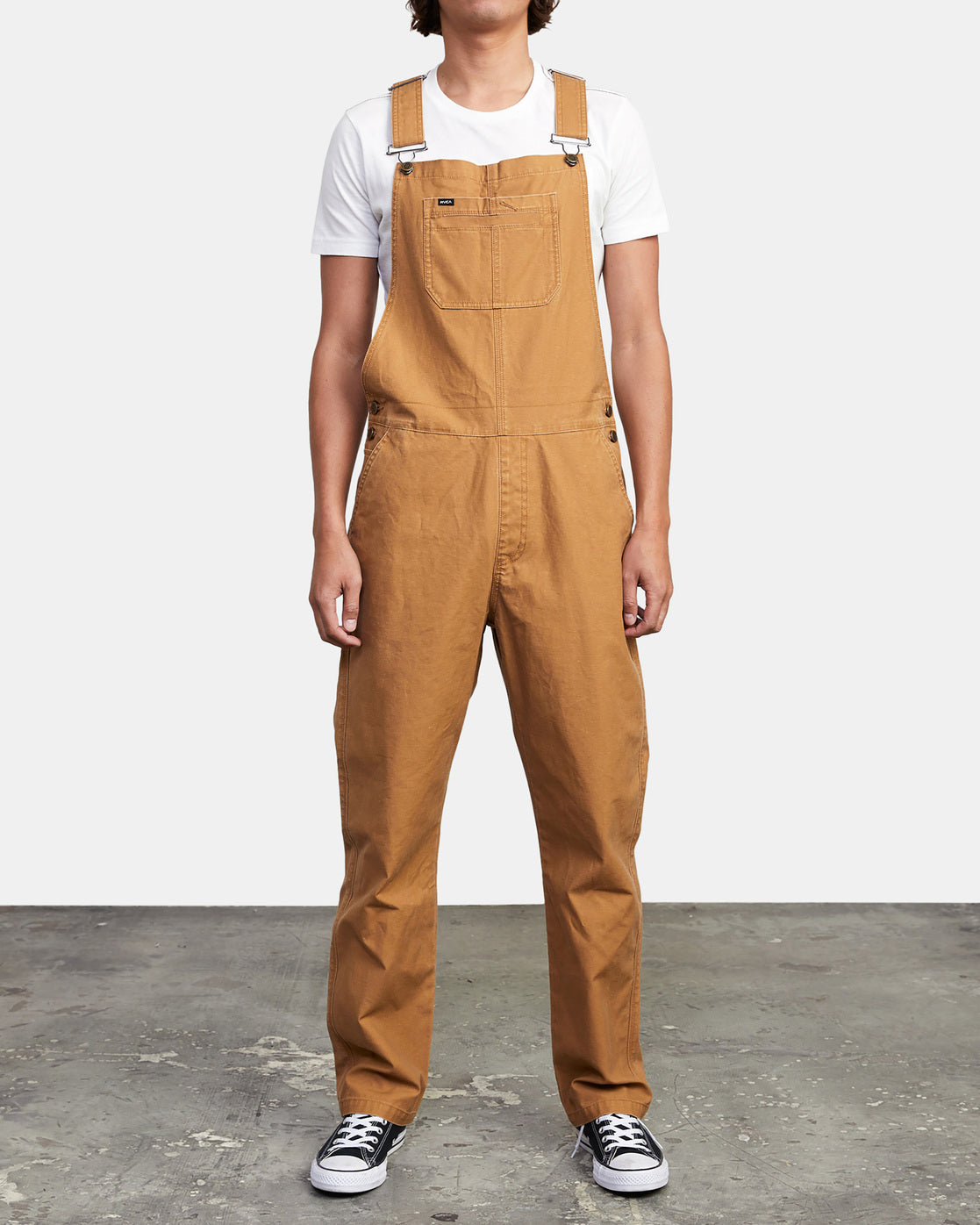 Men's cotton overalls from RVCA with open top tack buttons and adjustable suspenders and waistband.