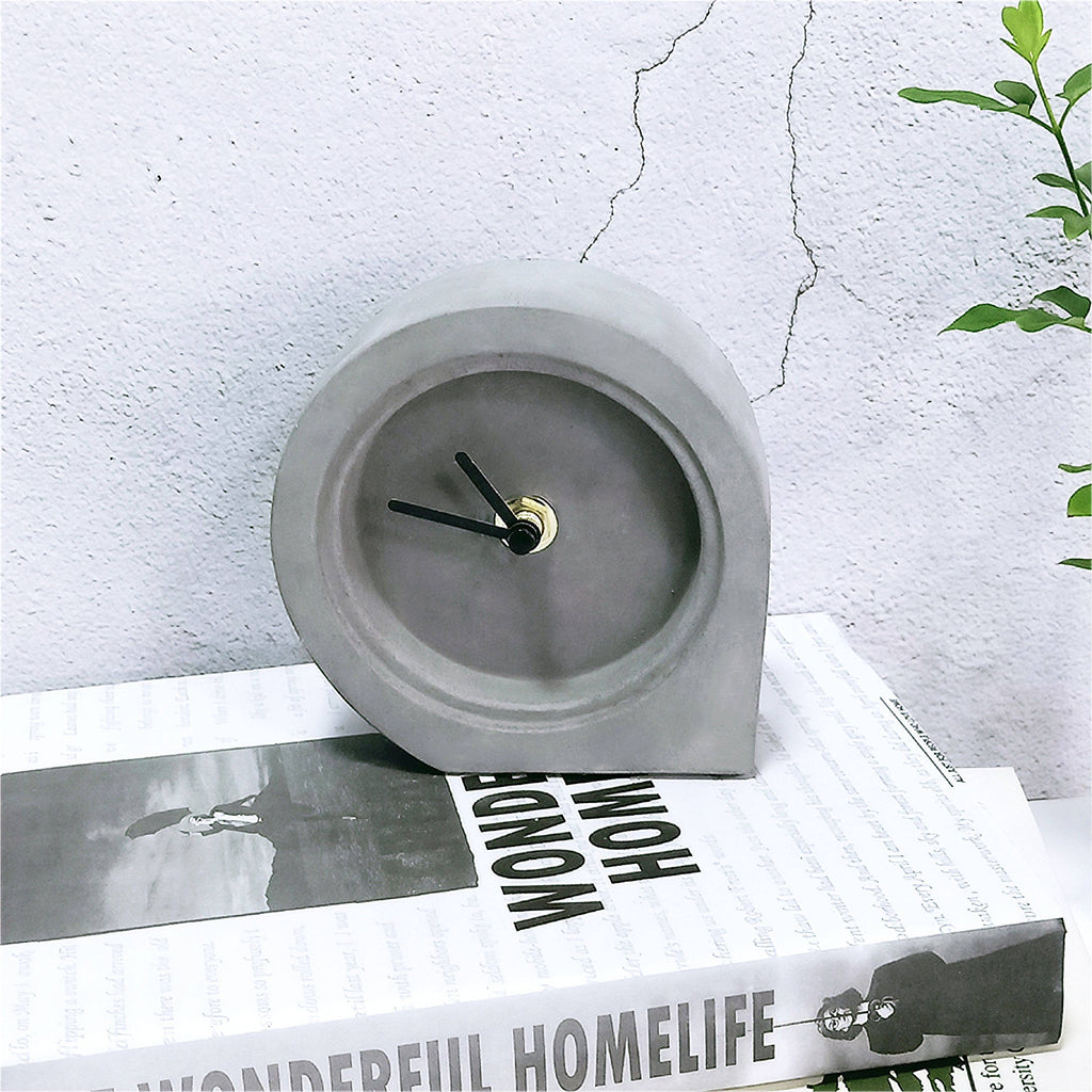 A modern and contemporary design on a classic free-standing clock. This beautiful concrete timepiece will fit perfectly in any home, living room or office. Made of durable concrete with a smooth finish and none surface marking qualities. A great and multi-functional gift. Mad man, masters of men's gifts. Material: concrete. Dimensions: 4.5" x 4.5" x 1.5".