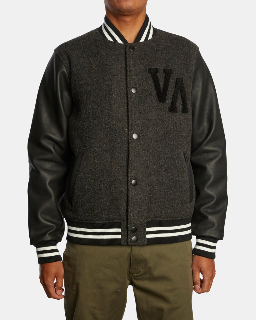 Combining bold style and effortless comfort, the RVCA Junior Varsity Letterman Jacket has you covered! Made from a warm blend of wool and polyester fabrics in a sleek satin finish. With genuine leather sleeves, light polyester fill at the body, heavy sweater knit rib at the collar, cuffs and hem. This men's jacket offers a classic look with modern function design. 