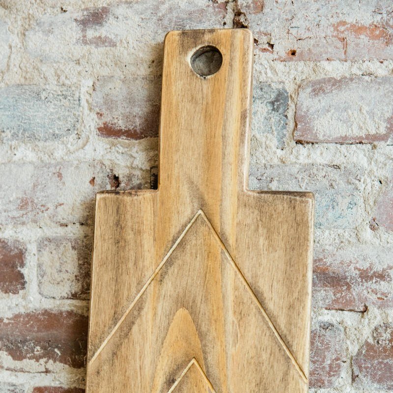 Customize your tablescape and kitchen with this wooden cutting board and/or serving tray. Our multi-functional boards are cured with FDA approved food safe oil. 29" x 8" Grace Graffiti™ is an American Made company. We design, make and ship all of our handcrafted products in our studio in Historic Downtown Brunswick, Georgia. All items are hand cut and given a distressed finish, accentuating the natural grain and charm of the wood. Each piece of wood is unique, items will vary slightly from the photographs.